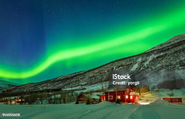 Northern Lights Over House At Norway Countryside Stock Photo - Download Image Now - Tromso, Norway, Aurora Borealis