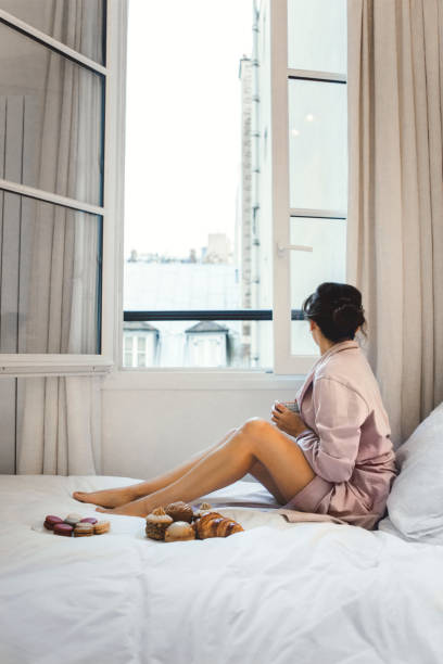 istock Woman having breakfast in bed in Paris 944060526