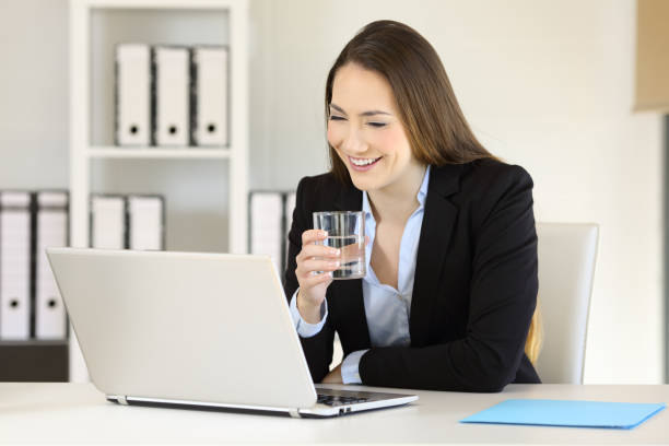 istock Office worker working holding a glass of water 944064128