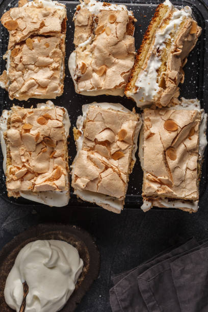 istock Cake with meringue and whipped cream, dark background, top view. 944065534
