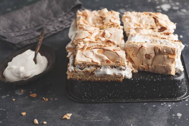 istock Sliced cake with meringue and whipped cream, dark background 944065826
