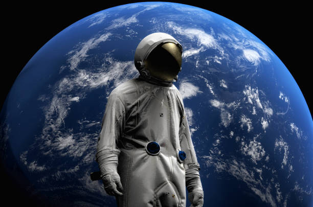 istock Astronaut on space mission flying around our blue planet. Earth on background. Cosmos. 3D render 944068802