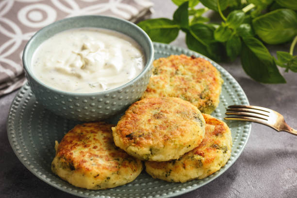 istock Broccoli and potato cutlets with cheese and yogurt dip. 944069108