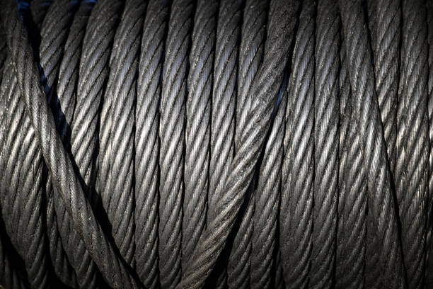 hintergrund mit einem gewickeltem stahlseil. - steel cable wire rope rope textured stock-fotos und bilder