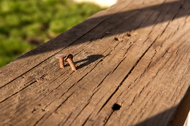 istock Rusty nail in a wooden board 944072554
