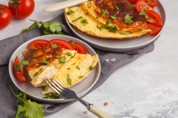 istock Delicious bright egg omelet with cheese and vegetables. Breakfast food concept, white background 944077034