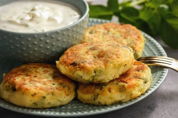 Broccoli and potato cutlets with cheese and yogurt dip.