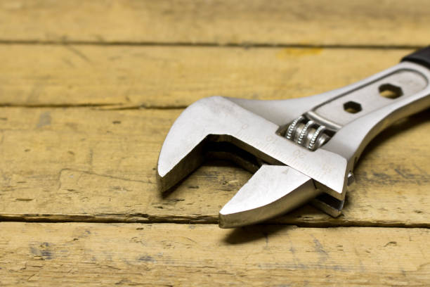 istock Adjustable wrench on a wooden workbench 944080326