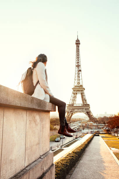 istock Woman looking at the Eiffel Tower in Paris 944080518