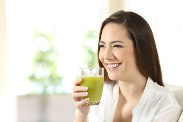 istock Woman drinking a vegetable juice looking away 944081060
