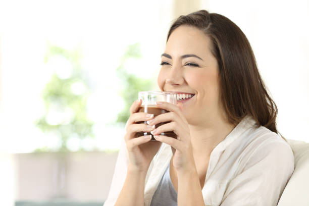 istock Candid girl drinking cocoa shake at home 944081258
