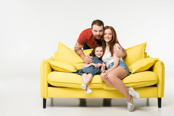 istock Man hugging wife and daughter isolated on white 944082144