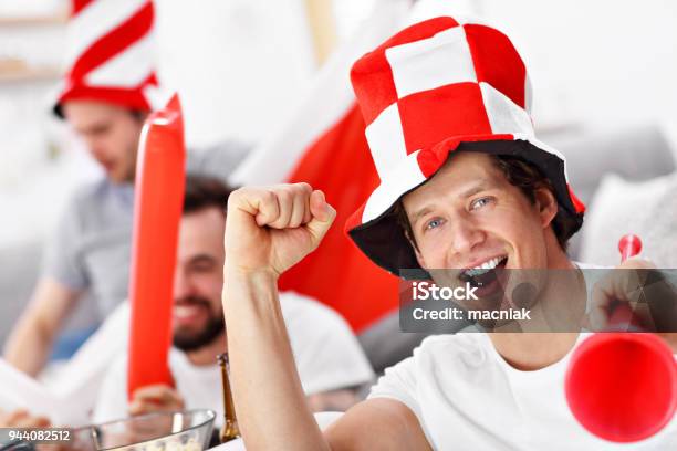 Happy Male Friends Cheering And Watching Sports On Tv Stock Photo - Download Image Now