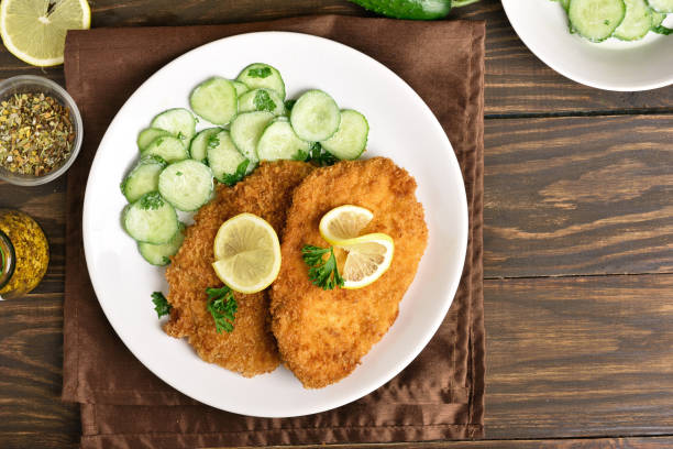 istock Tasty schnitzel with cucumber salad 944084728