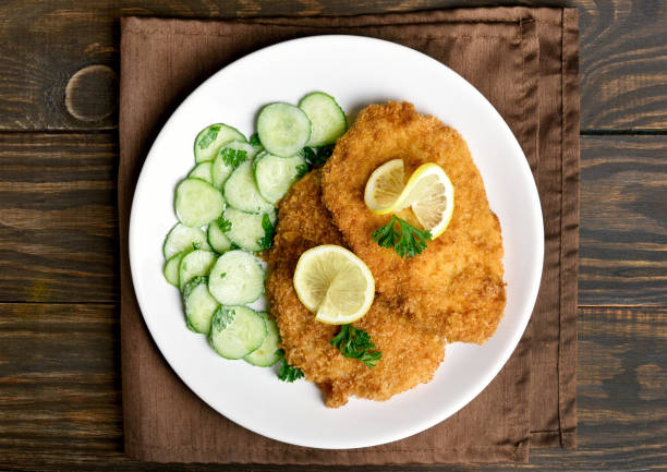 istock Tasty schnitzel with cucumber salad 944084734
