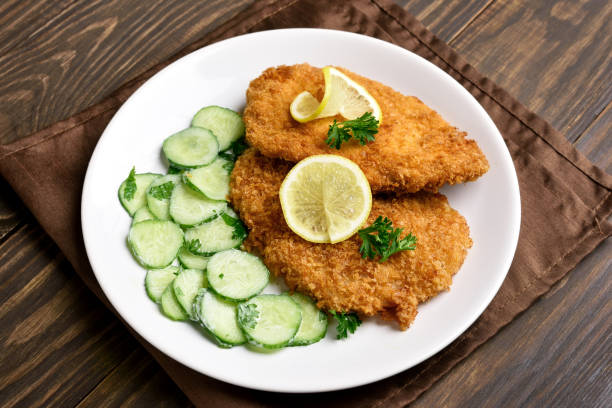 istock Tasty schnitzel with cucumber salad 944084736