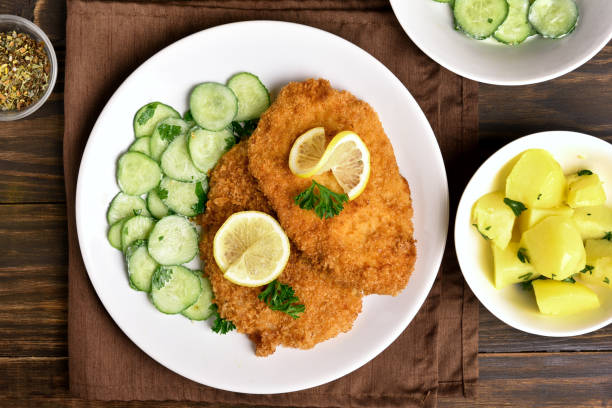 istock Tasty schnitzel with cucumber salad 944084754