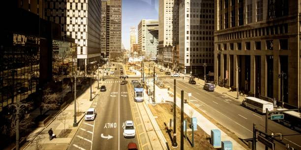 Downtown Detroit Michigan City Street With Traffic Detroit, Michigan, USA - March 20, 2018: Downtown Detroit Michigan cityscape looking down Woodward Avenue with traffic and skyscrapers. woodward stock pictures, royalty-free photos & images