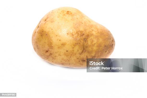 Single Large Yellow Potatoe On A White Background Stock Photo - Download Image Now - Agriculture, Brown, Carbohydrate - Food Type