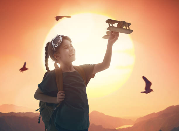 istock girl playing with toy airplane 944094026
