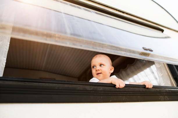 istock Baby boy in a camper van. 944097630