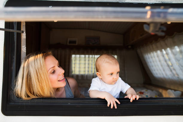 istock Mother and baby son in a camper van. 944098518
