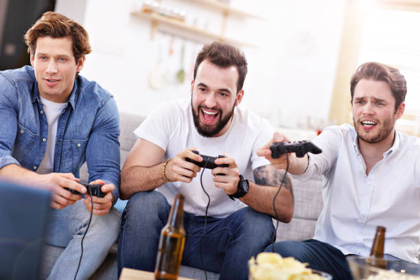 istock Friends having fun on the couch with video games 944098648