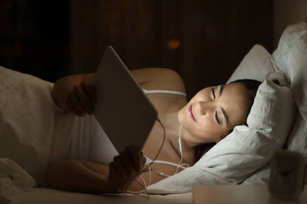 istock Woman watching media in a tablet in the night 944098682