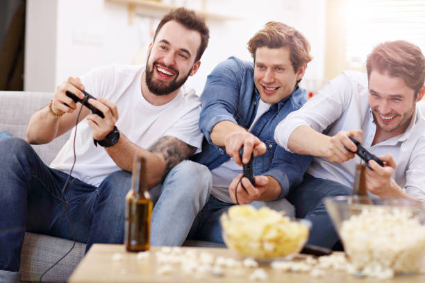 istock Friends having fun on the couch with video games 944102252
