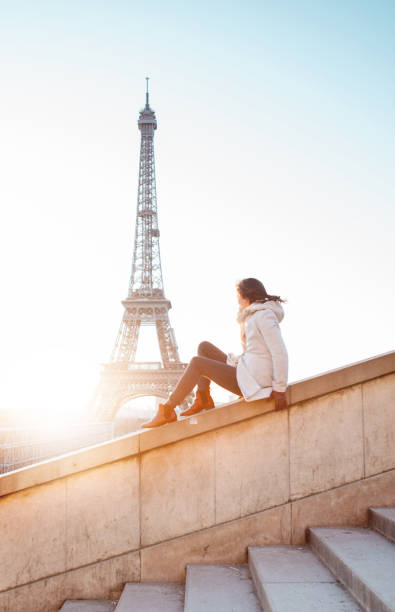 istock Woman looking at the Eiffel Tower in Paris 944102520