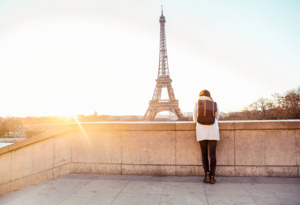 istock Woman looking at the Eiffel Tower in Paris 944102542