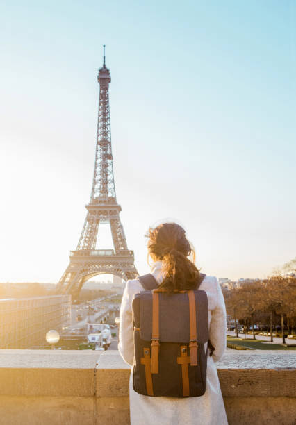 istock Woman looking at the Eiffel Tower in Paris 944102544