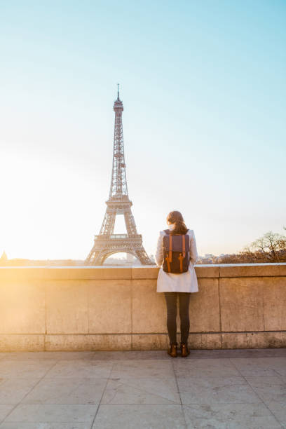istock Woman looking at the Eiffel Tower in Paris 944102614