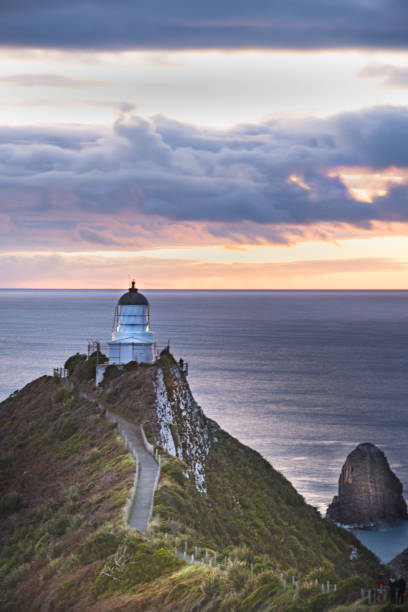 istock Lighthouse sunrise at Nugget Point,Tokata Wall 10 944103478