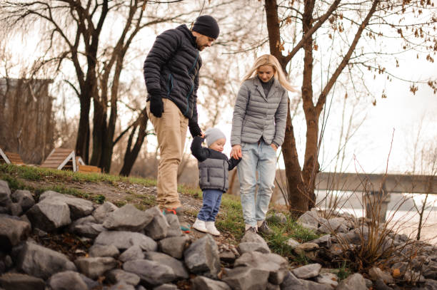 istock Young and happy parents walking with a little son 944108412