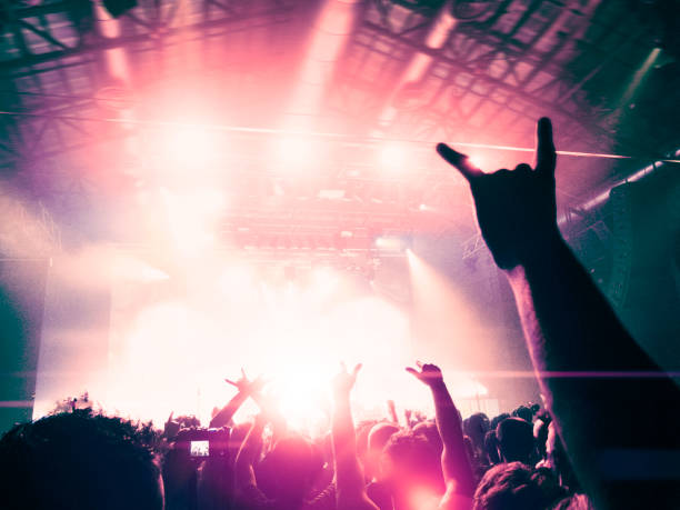 istock Concert crowd dancing in front of a colourful stage 944112410