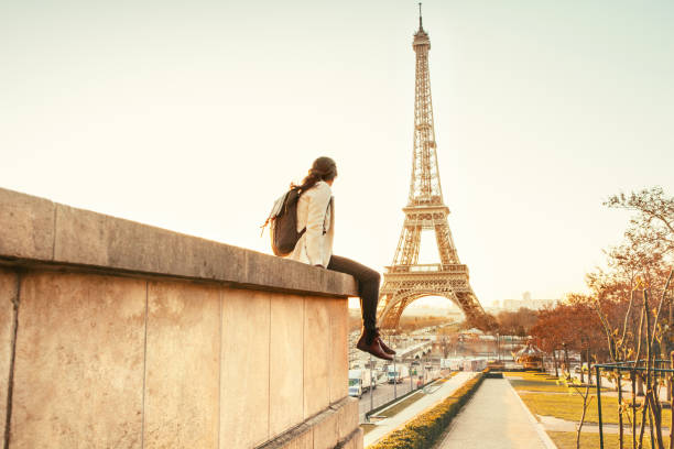 istock Woman looking at the Eiffel Tower in Paris 944112572