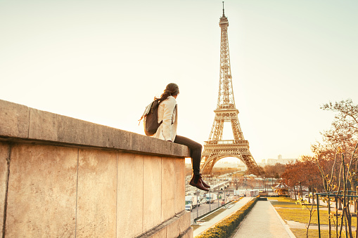 Woman looking at the Eiffel Tower in Paris