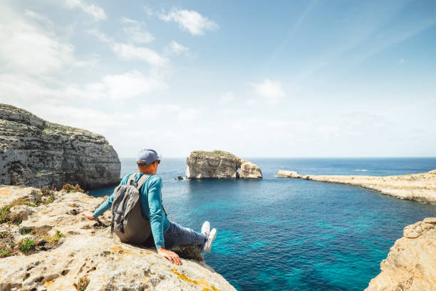 istock Coastal walker relax on rocky seaside 944112748