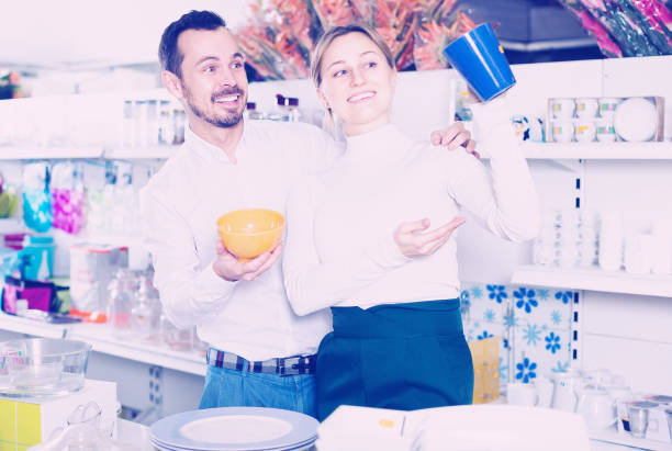 istock Couple picks out  ceramic  crockery 944124732
