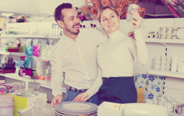 istock Man and a girl are looking for kitchen utensils 944124978