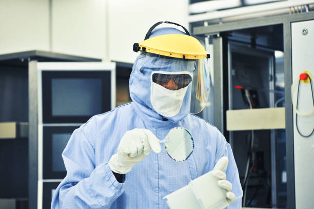 Scientist Working on (Silicon) Semiconductor Fabrication in Cleanroom Silicon Wafer Under Cleanroom Fabrication photodiode stock pictures, royalty-free photos & images