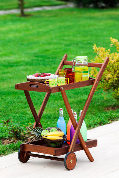 Serving trolley on wheels for dining or drinks in garden.