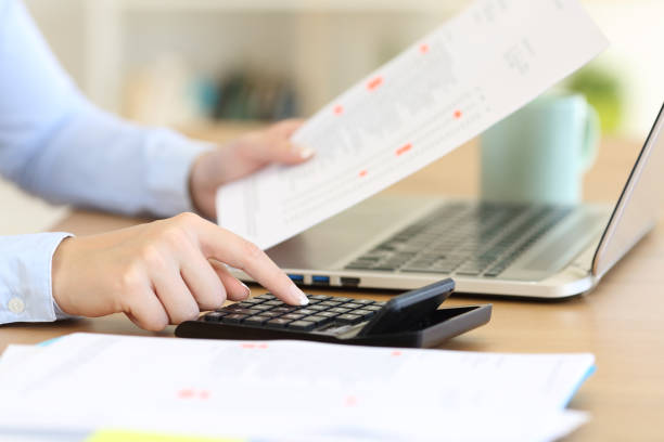 Accountant calculating with a calculator on a desk