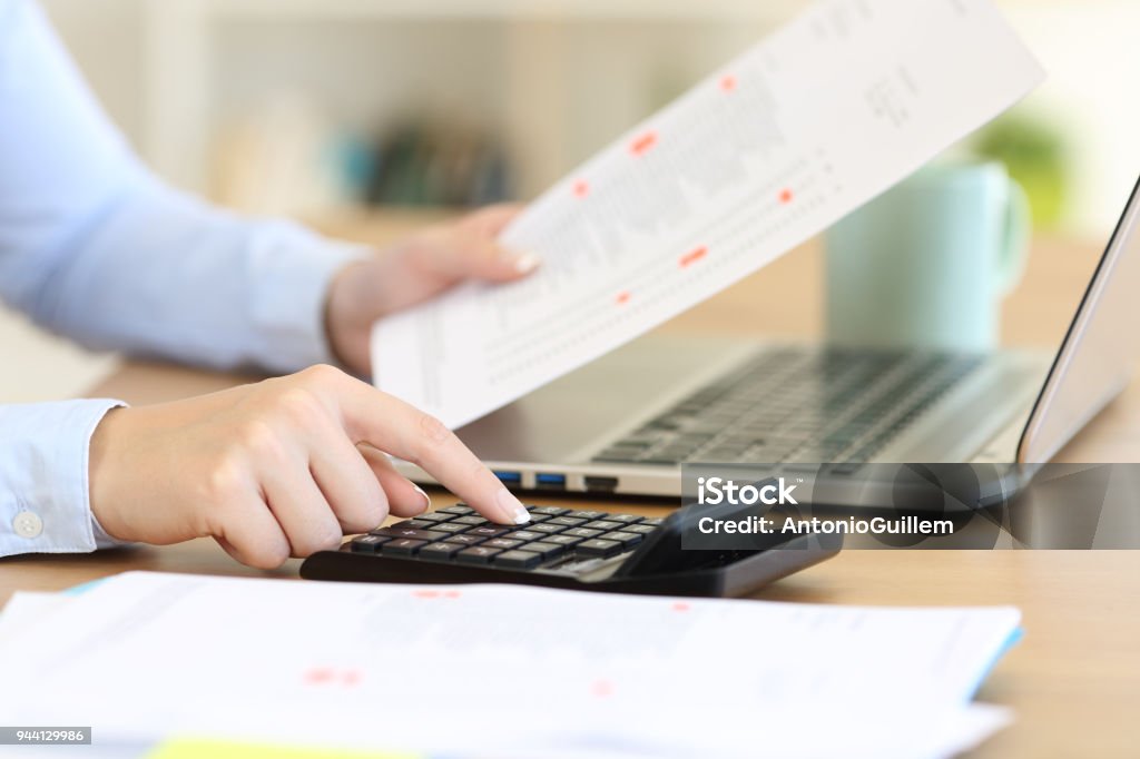 Accountant calculating with a calculator on a desk Close up of an accountant hands calculating with a calculator on a desk Home Finances Stock Photo