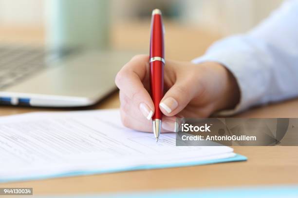 Businesswoman Hand Signing A Contract On A Desk Stock Photo - Download Image Now - Signing, Contract, Document