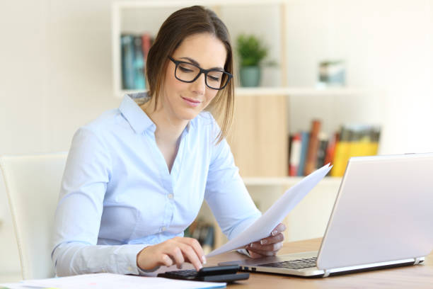 istock Woman calculating with a calculator at home 944130706
