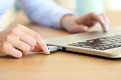 Woman hand connecting a pendrive in a laptop