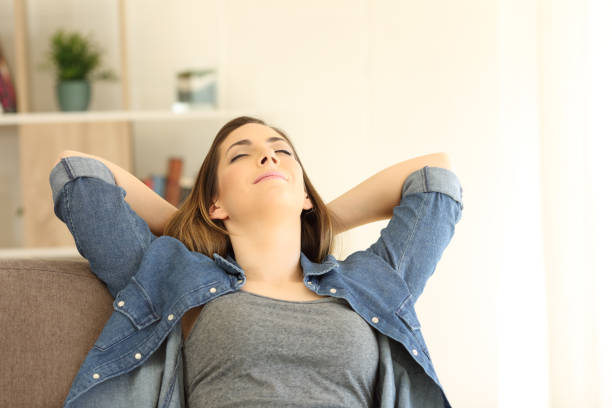 istock Woman relaxing sitting on a couch at home 944131148