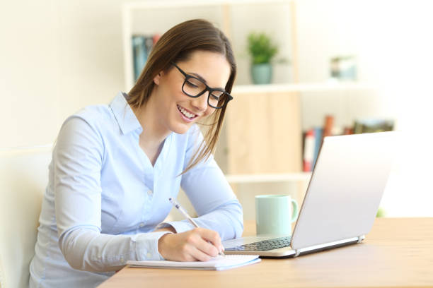 istock Woman writing in a notebook at home 944131642